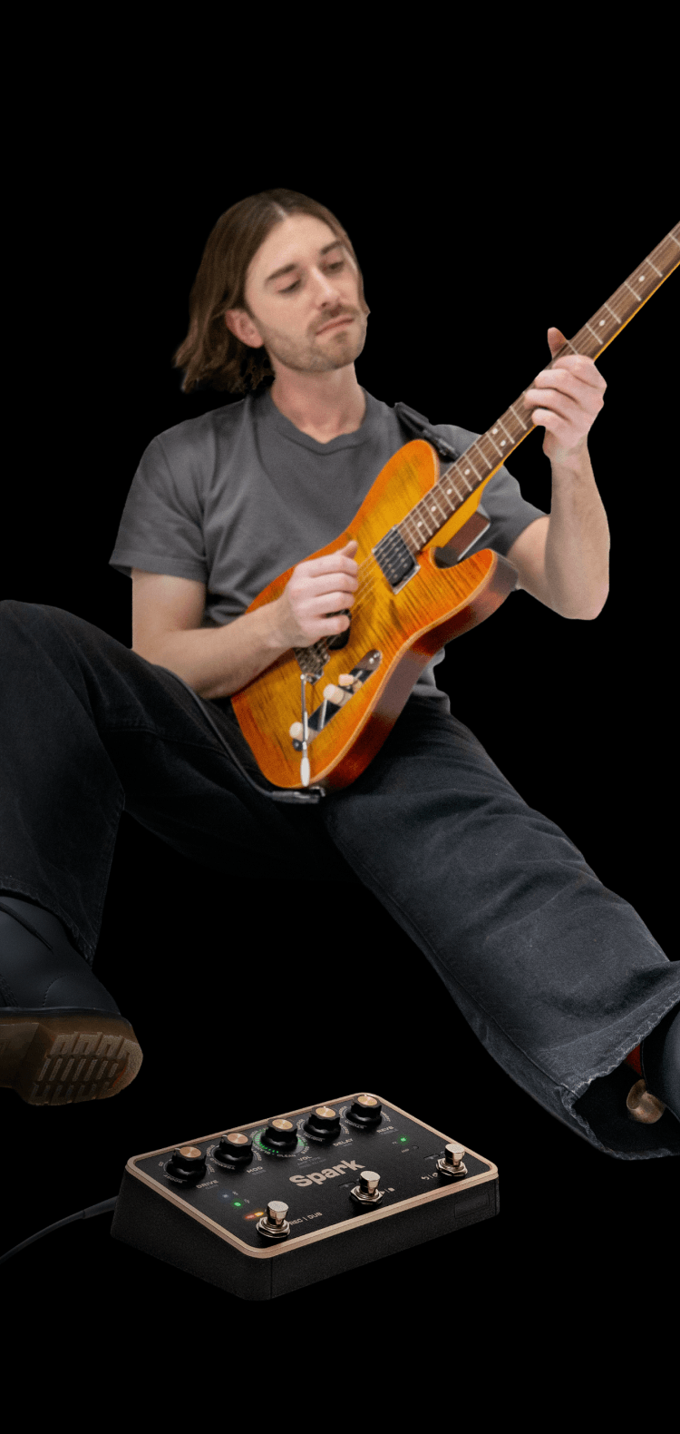 Guitarist leaning back mid-jam, Spark PEDAL on the floor beside him